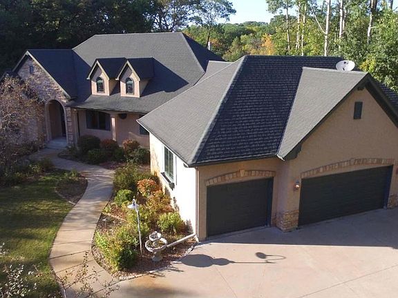 Executive Rambler surrounded by trees and nature views.