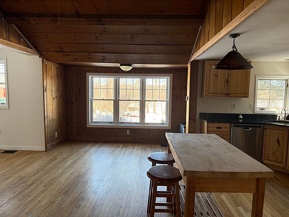 This is a picture of the kitchen area and dining area from the doorway of the third bedroom.