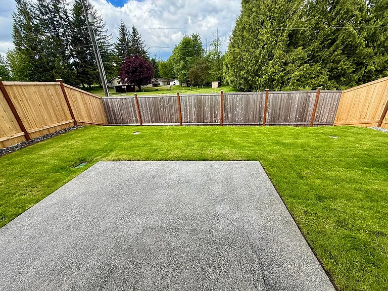 Spacious patio and backyard overlooking green area and lots of privacy