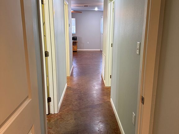 Hallway from large bedroom looking into kitchen/living area
