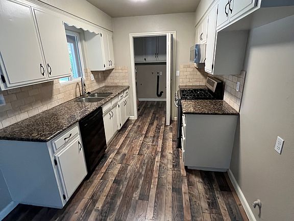 Kitchen with access to laundry room and backyard.
