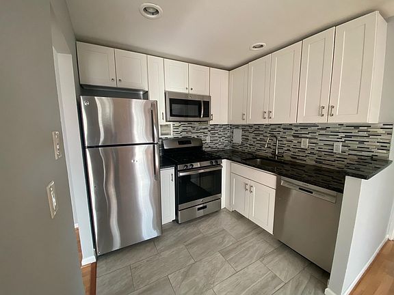 Modern kitchen with granite top and stainless steel appliances
