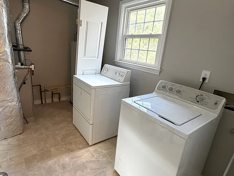 Separate Laundry Room off the back hall with a window overlooking the backyard