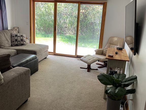 Living room and sliding door to back patio and yard.