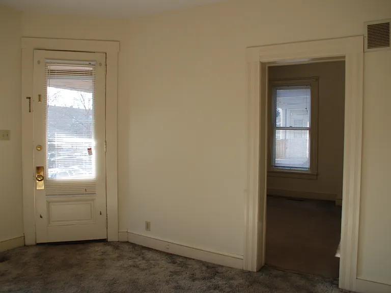 Living room front door and looking into bedroom #1.