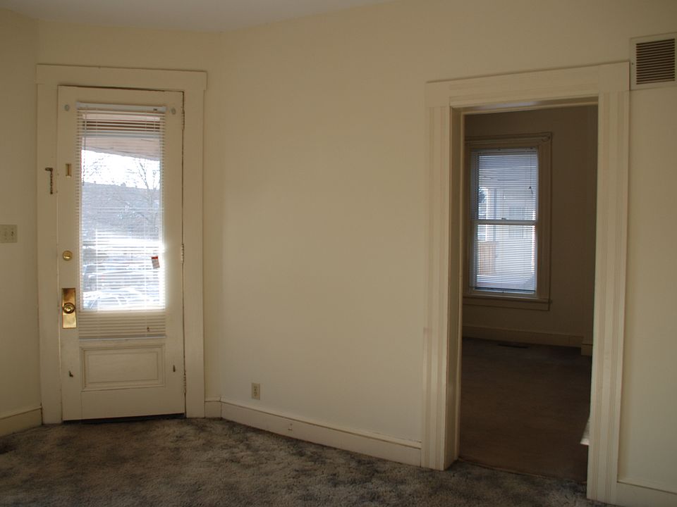 Living room front door and looking into bedroom #1.