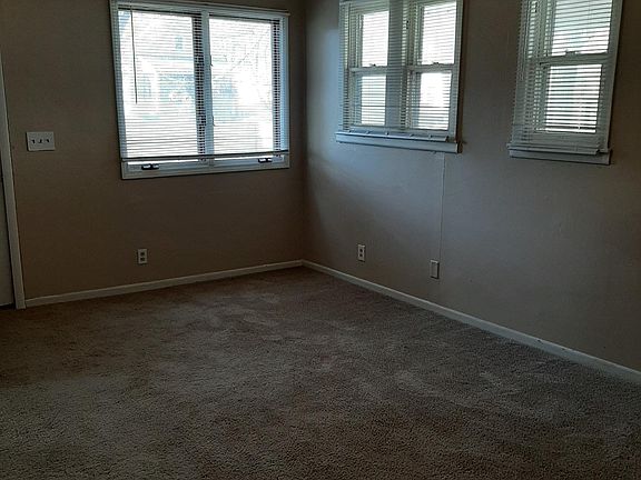 Living room looking to north wall (on right) and west wall which is at front of house; front entry door is just out of view on left