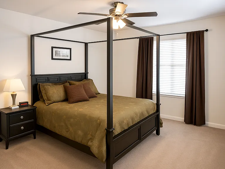 Spacious bedroom with natural light and room for a full or queen bed setup.