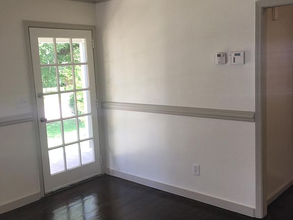 Original refurbished front door and chair rails in living room