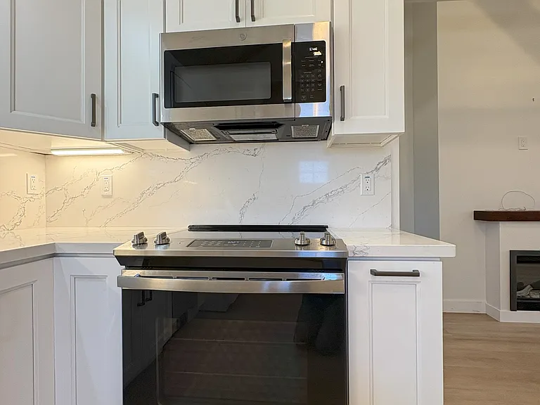 Kitchen has a microwave and electric oven-range