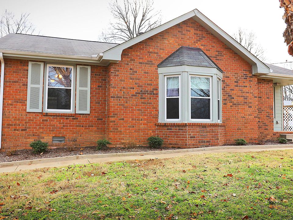 Front of house entryway with off street parking.