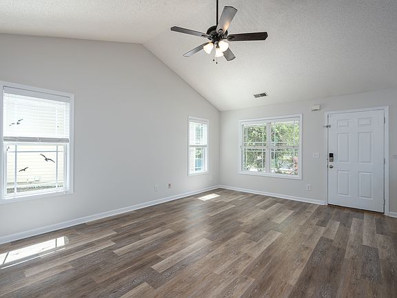 Living Room _ Open, light-filled living space with luxury vinyl flooring throughout.