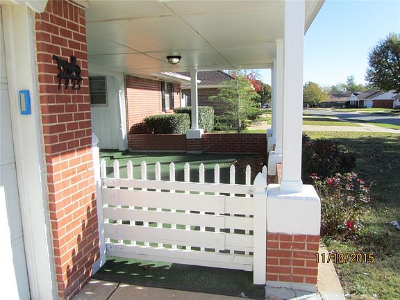Nice covered gated front porch with outdoor carpet.
