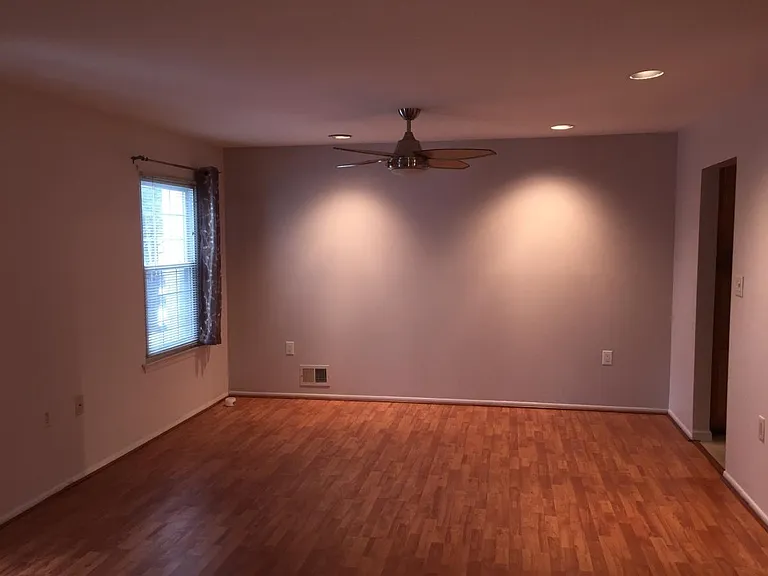 Living room with recessed lights and fan