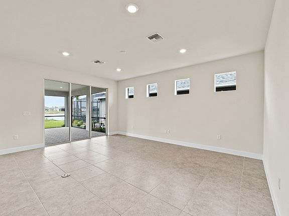 Additional view of gathering room with sliding glass door to extended covered lanai