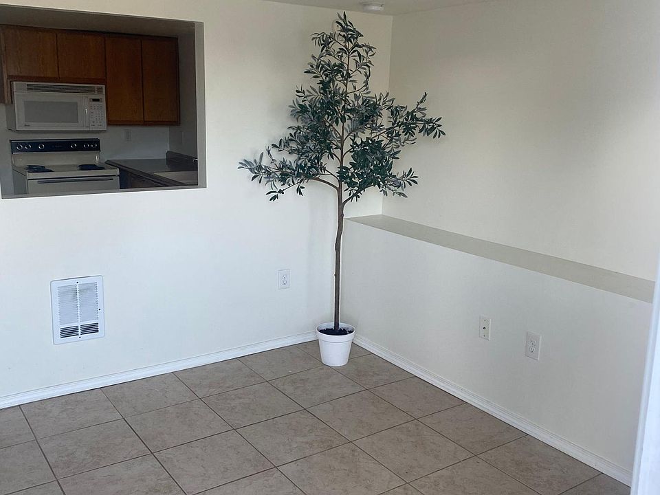 living room with just the nature light and kitchen in the back
