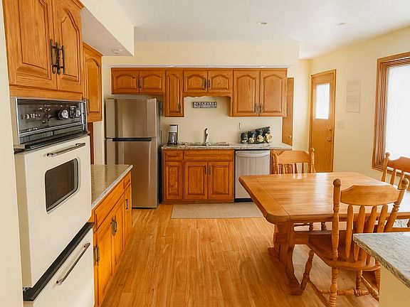 Bright, functional kitchen with warm wood cabinetry, ample storage, and full appliance package.
