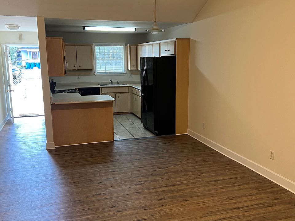 Living room looking at kitchen and front entrance