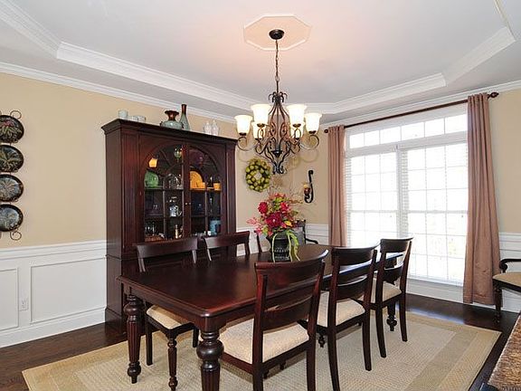 Large dining room has detailed molding and hardwood floors
