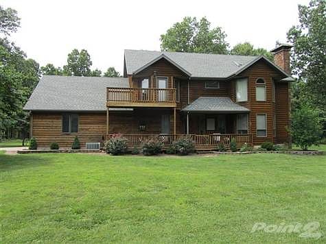 Covered front porch with lovely landscaping