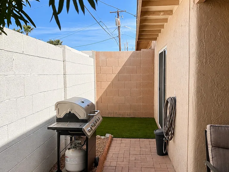 Backyard patio alt angle with covered table and chairs