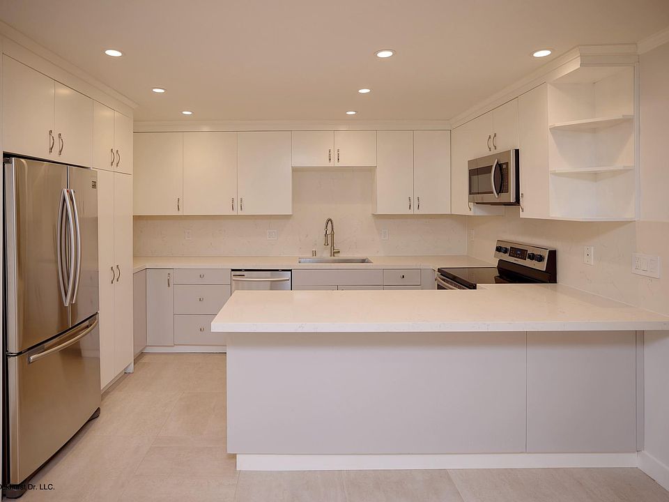 Remodeled kitchen with stainless steel appliances, quartz counters and custom cabinets