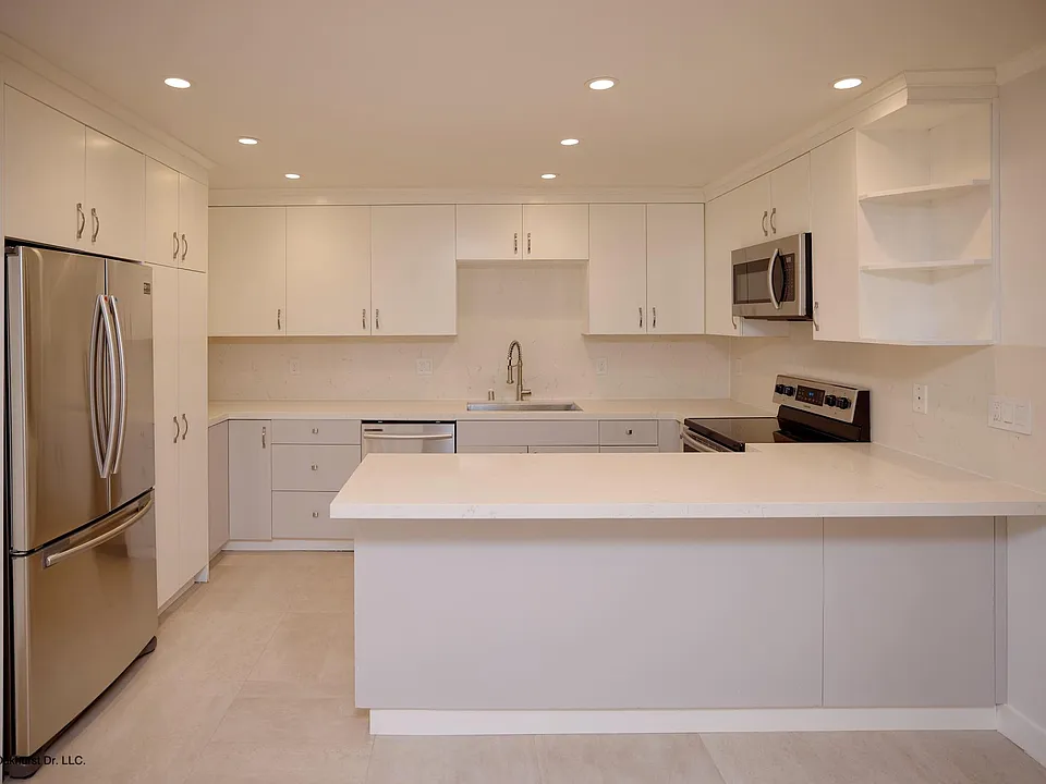 Remodeled kitchen with stainless steel appliances, quartz counters and custom cabinets
