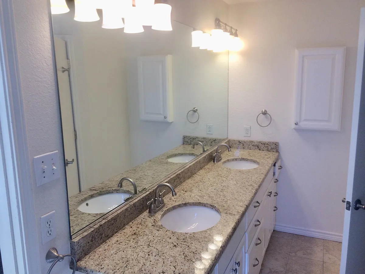 Double Granite top Sinks in Master Bath - 1000 Travis St