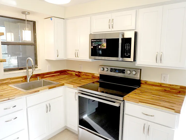 New kitchen appliances and cabinetry. Deep well stainless sink. Butcher block counter tops.