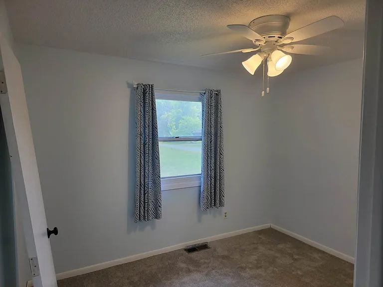 3rd bedroom has new paint, ceiling fan, drapes, big closet.