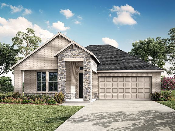 A two-story house with a stone exterior, a gabled roof, and a garage stands in a grassy yard surroun