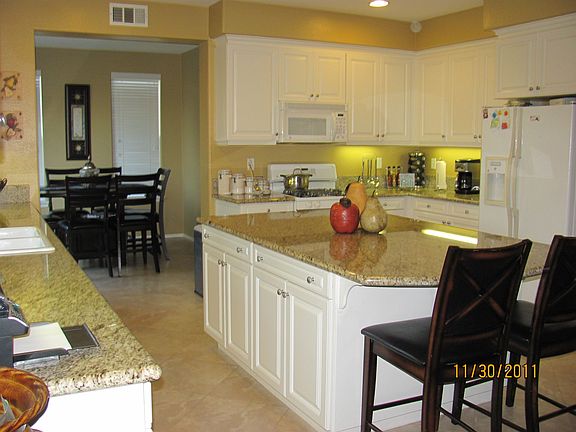 Large kitchen island with granite counntertops.