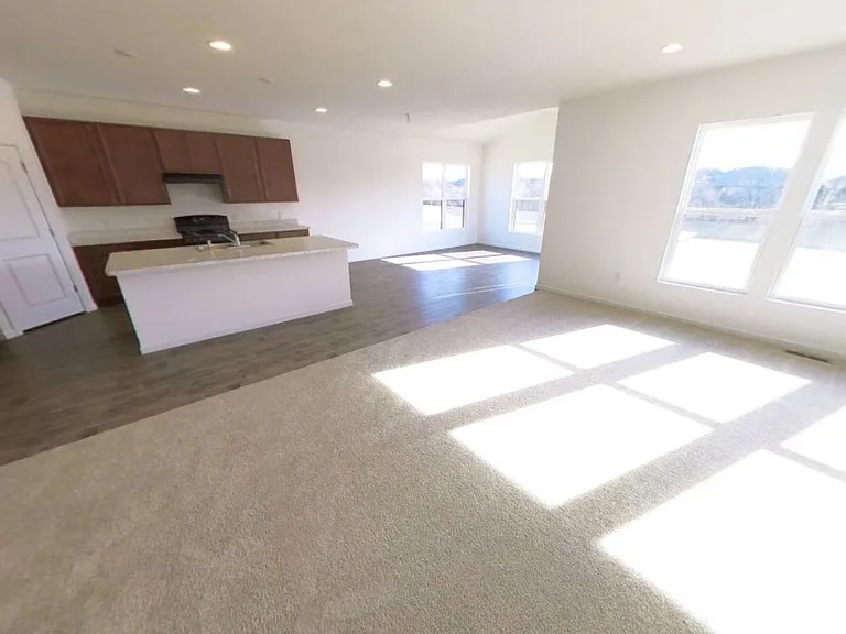 Large living room with open-concept layout connected to kitchen.