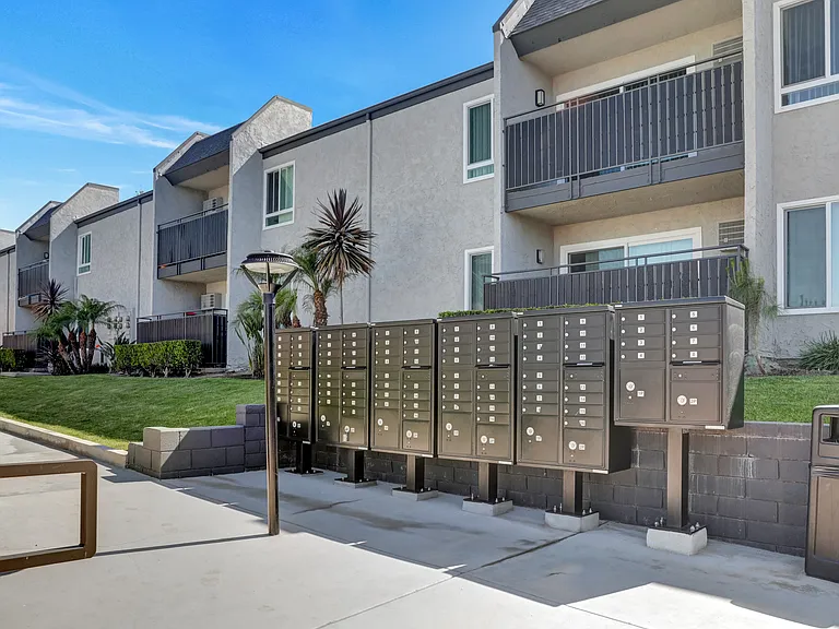 A building with a row of mailboxes in front of it.