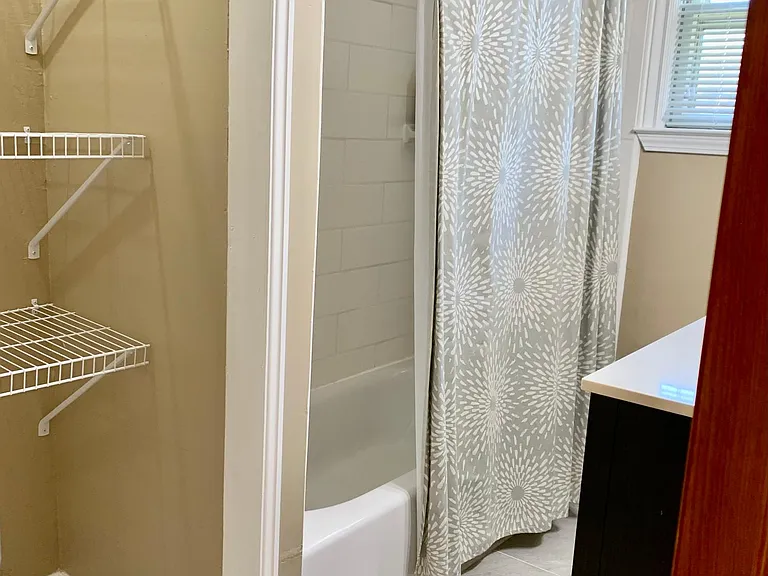 Main bathroom with storage shelves
