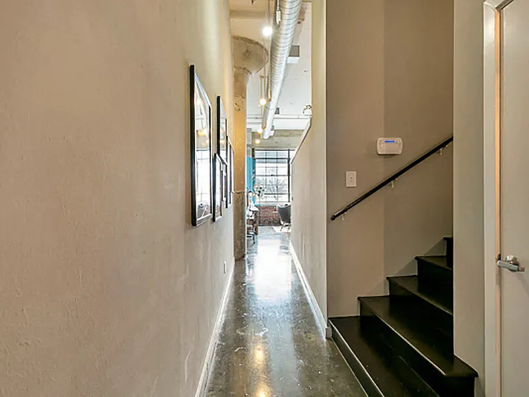 Long hallway with concrete flooring