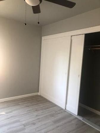 Second bedroom with same new laminate floor and fan light. shows closet size in each bedroom.
