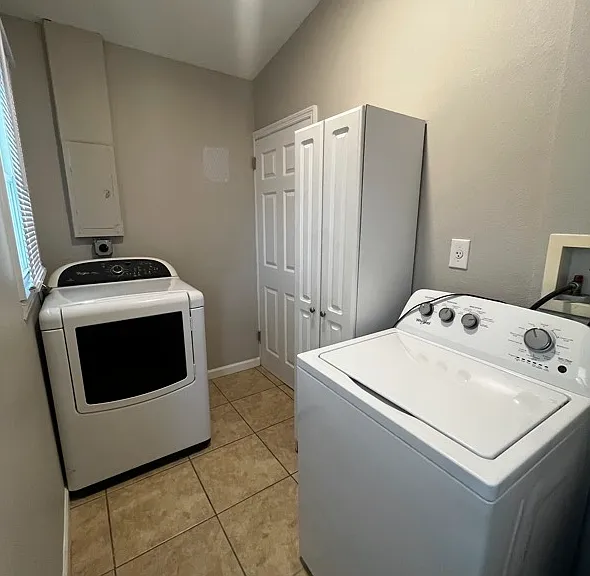 Laundry Room: Electric Washer & Dryer, Storage Cabinet