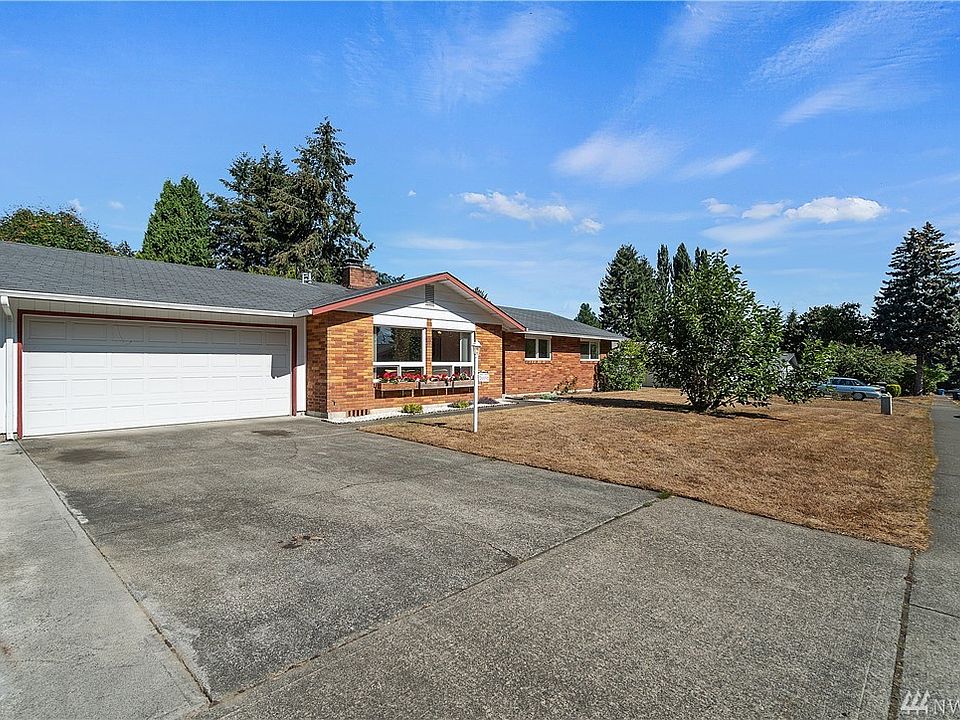 Front of home with extended driveway.