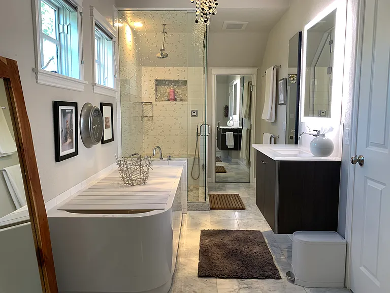 oversized deep tub and steam shower plus full bidet with heated seat. single sink with outlets underneath and hidden (for dryer connection, etc)