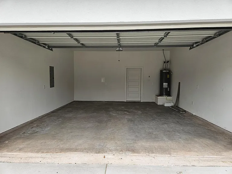 The two car garage can be opened with a remote or through the security app on your phone.