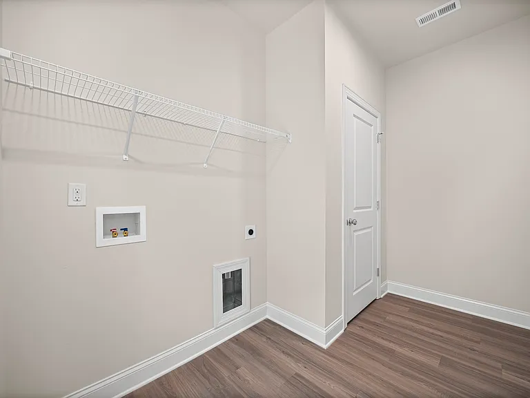 Laundry room with closets and shelves