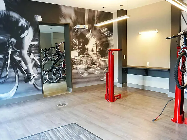 Indoor Bike Storage Room Featuring Repair Stands and Workstation