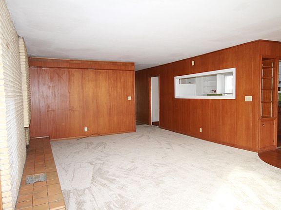 Living room view with Peekaboo window into kitchen