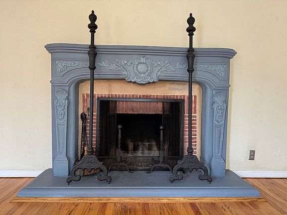 Grand French Chateau cement mantle wood burning fireplace.
