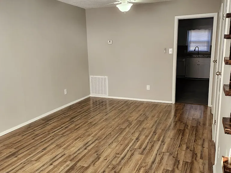 Living Room view; modern fan and lots of natural light, white fan and new venetian blinds.