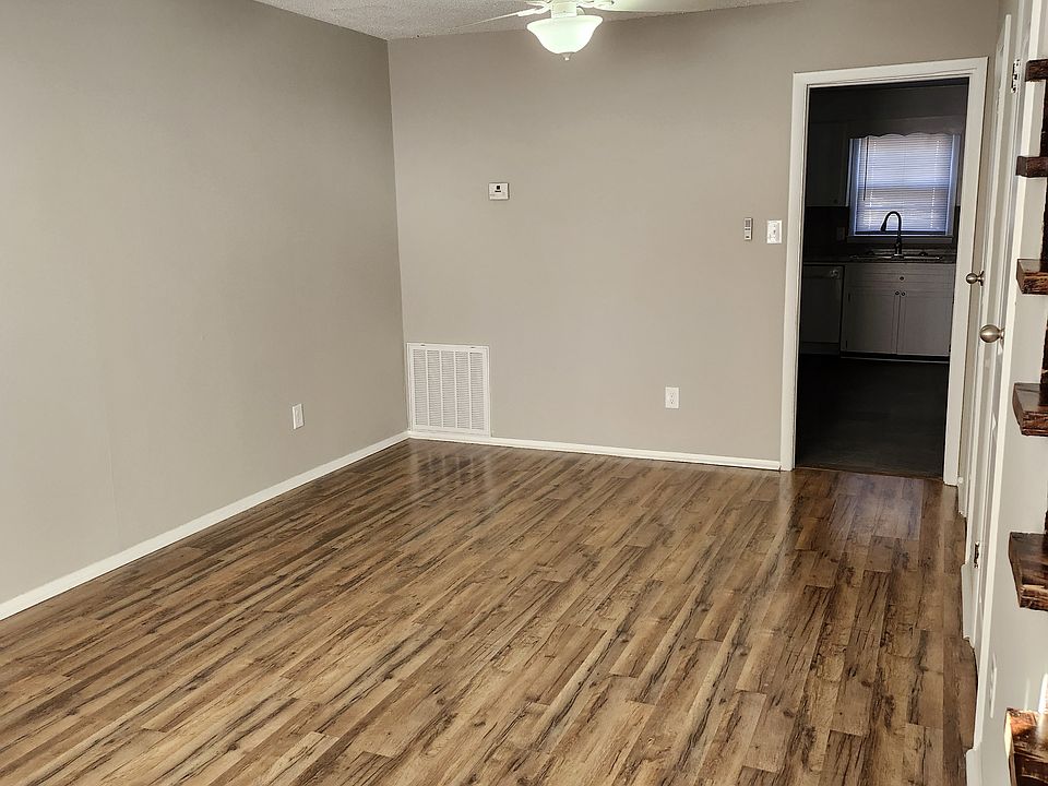 Living Room view; modern fan and lots of natural light, white fan and new venetian blinds.