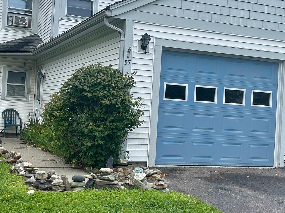 Attached single garage with custom shelving/organizational space and epoxy floor