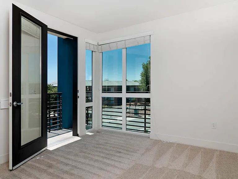 Carpeted Bedroom with Balcony