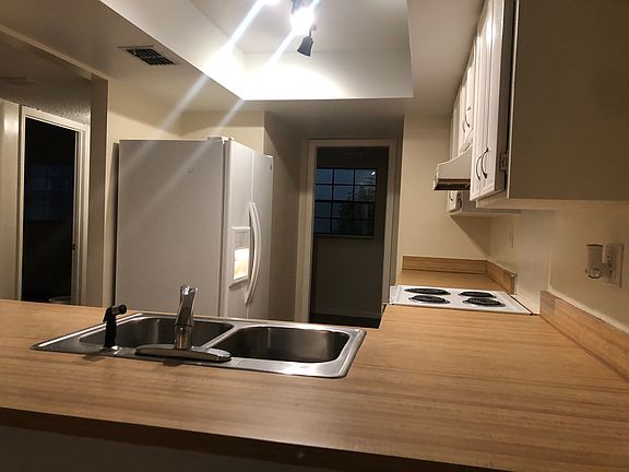 Kitchen and laundry room view from living/dining area